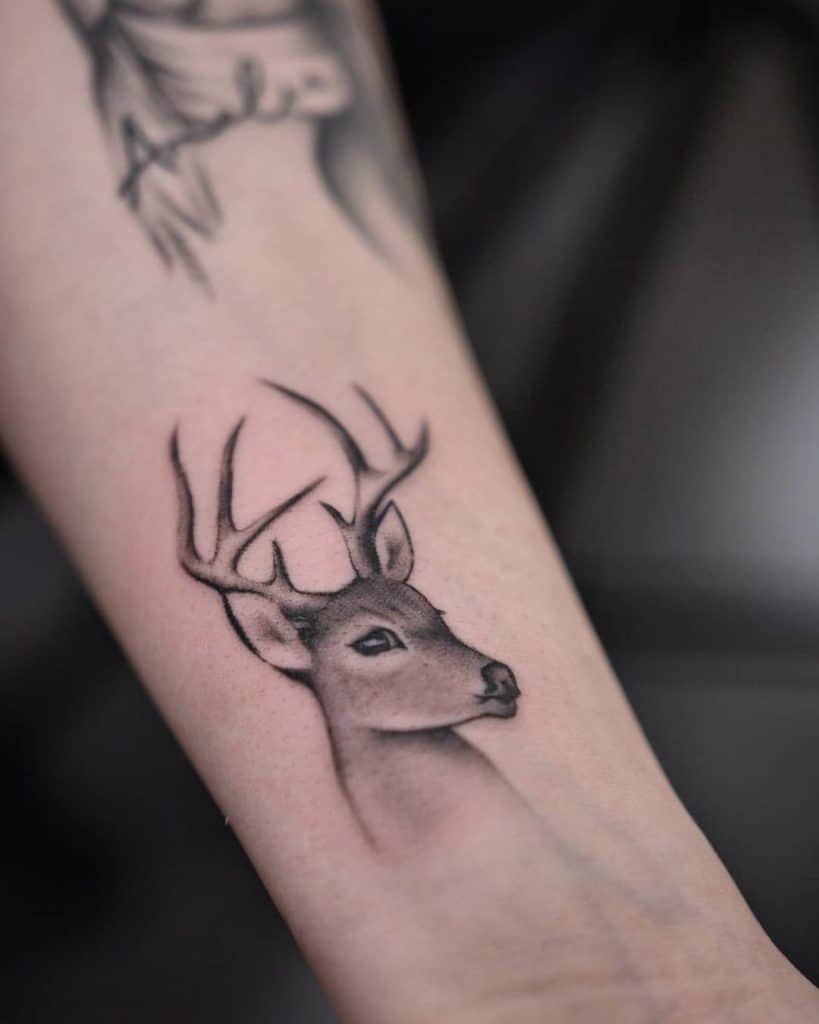 A sitting deer tattoo