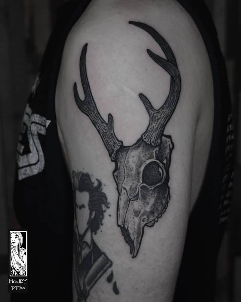 Deer Head Tattoo on The upper arm area