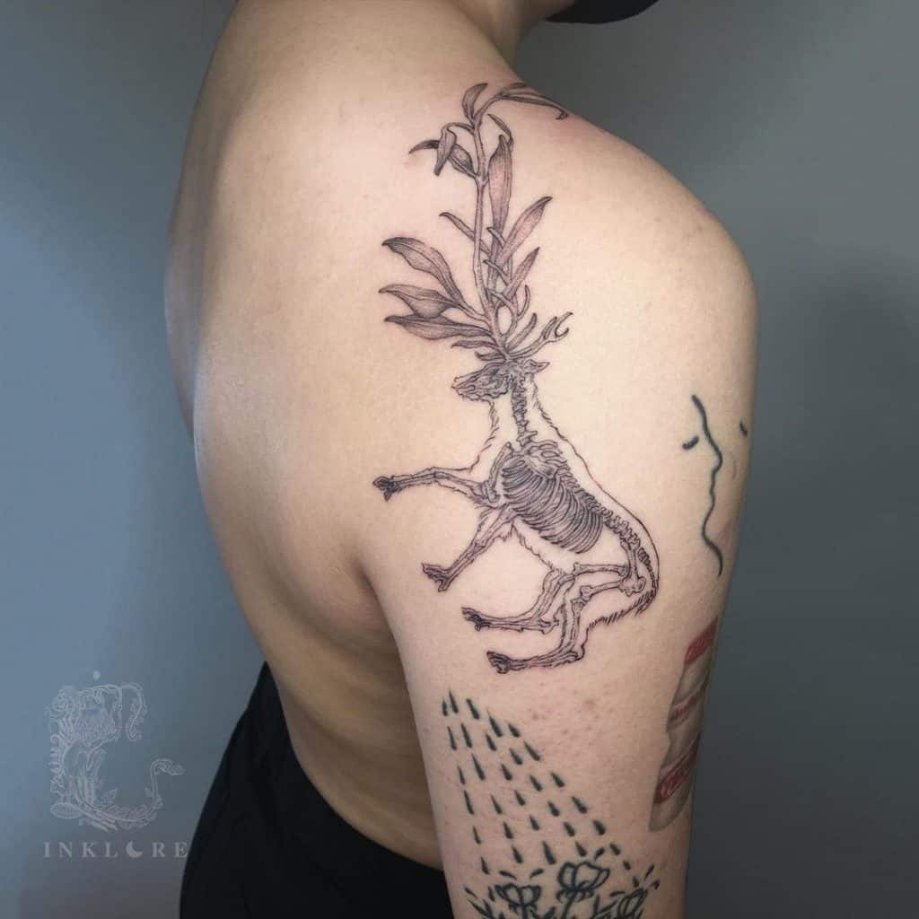 Deer tattoo on the upper back shoulder area 