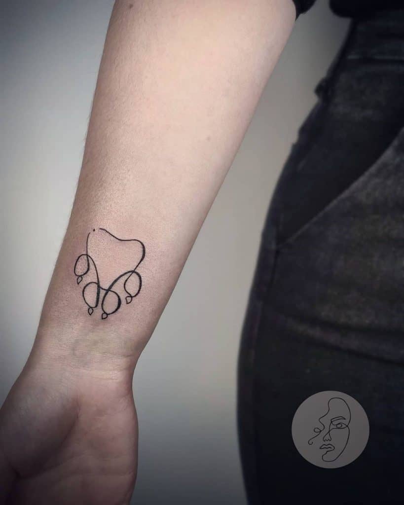 Minimalistic Dog Paw Tattoo on the Arm