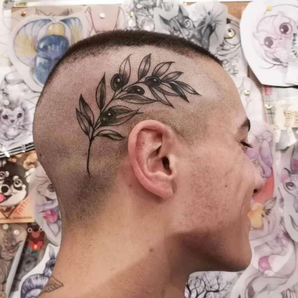 Olive branch tattoo on the scalp