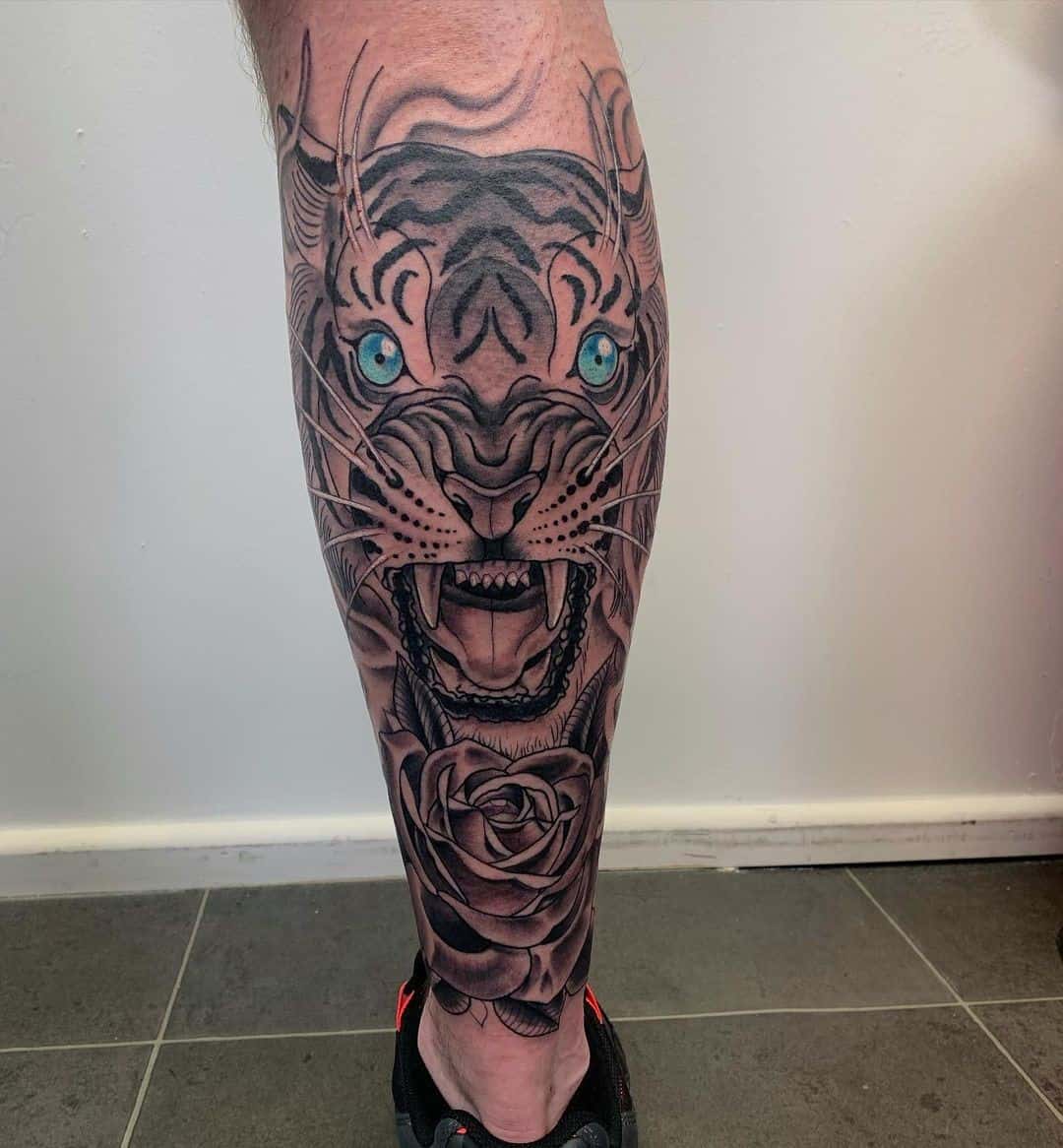 Tiger Tattoo Over Calf With Blue Eyes 