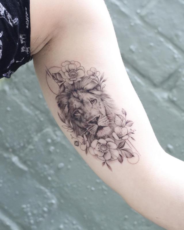 Lion In Flowers Tattoo Design