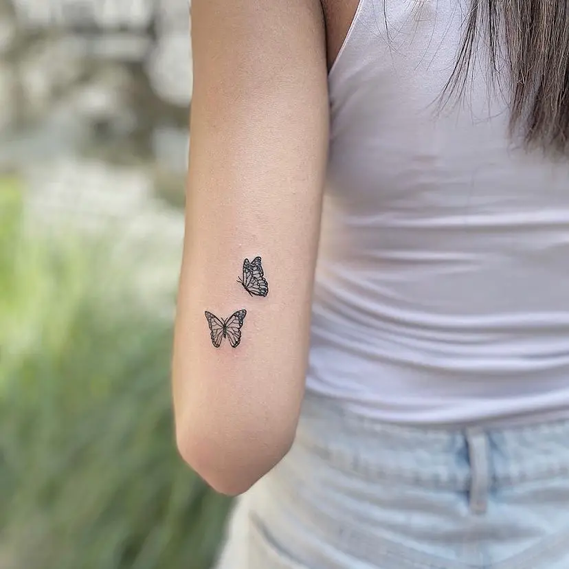 small butterfly tattoo on hand women