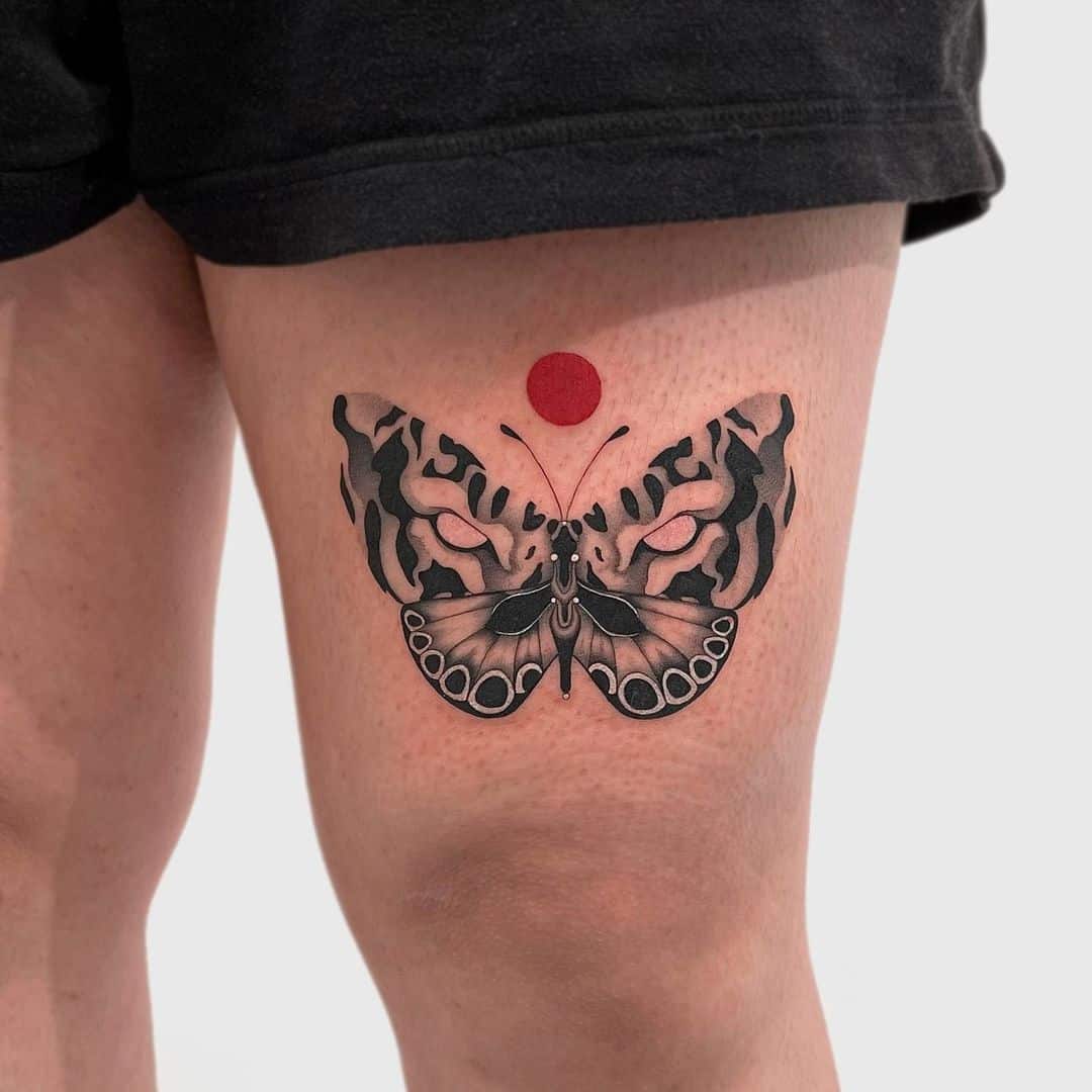 butterfly tattoo on the thigh